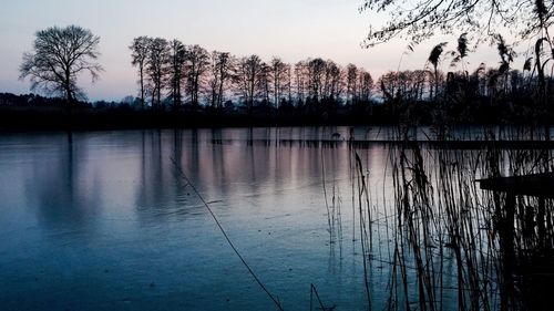 Scenic view of lake against sky at sunset