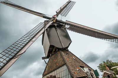 Low angle view of traditional windmill against sky