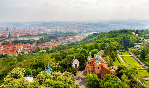 High angle view of trees and buildings in city