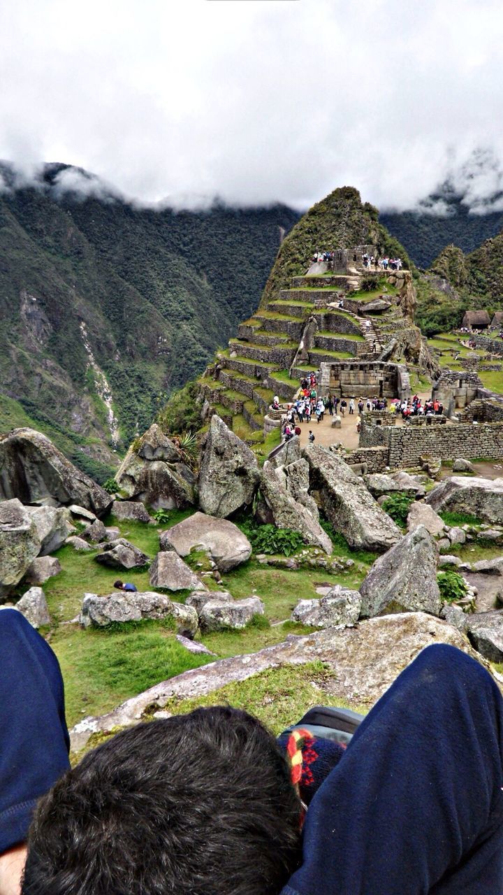 mountain, lifestyles, men, leisure activity, person, sky, rock - object, mountain range, rear view, landscape, scenics, hiking, cloud - sky, tourist, nature, sitting, large group of people