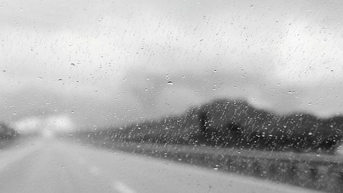 Road seen through wet glass