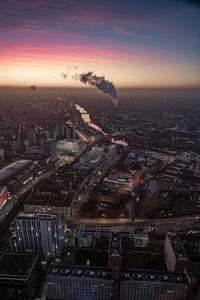 High angle view of buildings in city during sunset