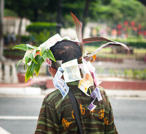 Man wearing wreath of paper currency