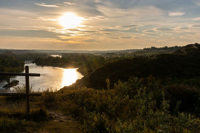 Scenic view of lake against sky during sunset