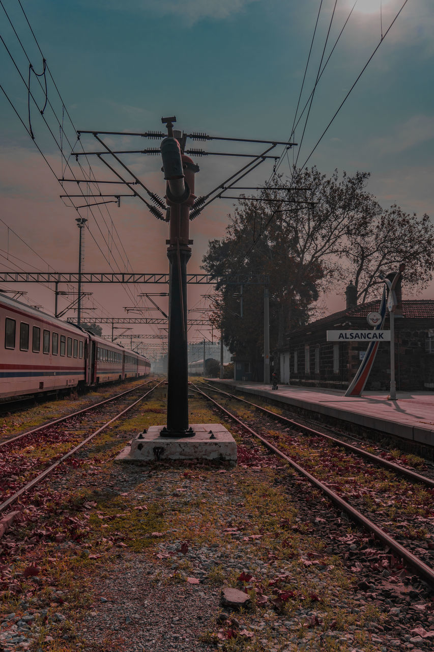 RAILROAD TRACKS AGAINST SKY AT STATION