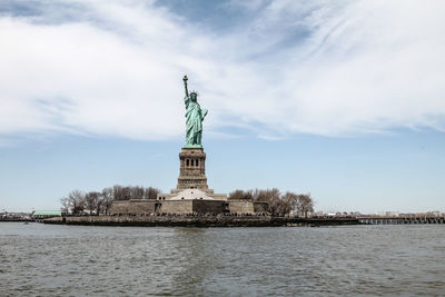 Statue of liberty against cloudy sky