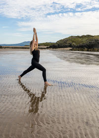 Full length of woman on beach against sky