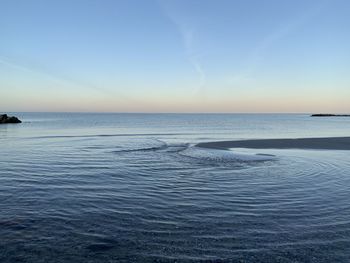 Scenic view of sea against clear sky during sunset