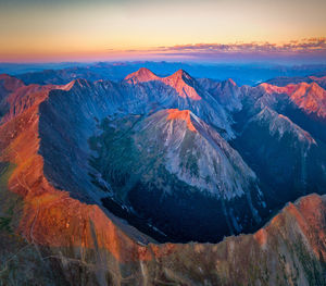 Scenic view of snowcapped mountains against sky during sunset