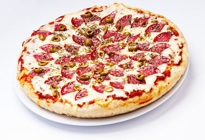 Close-up of pizza over white background