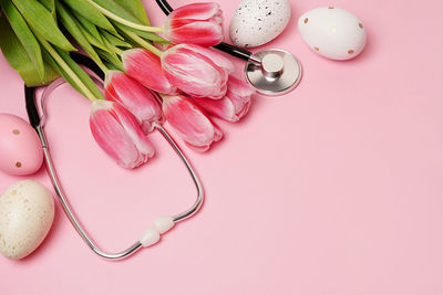 Directly above shot of easter eggs on pink background