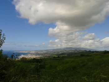 Scenic view of landscape against cloudy sky