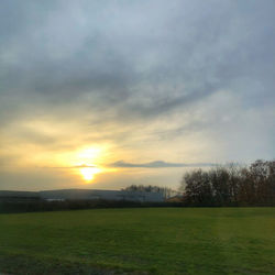 Scenic view of field against sky during sunset