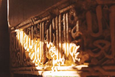 Close-up of illuminated candles in temple