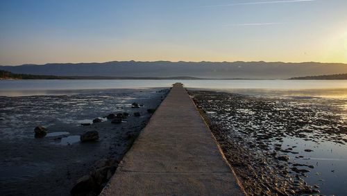 Scenic view of lake against sky during sunset