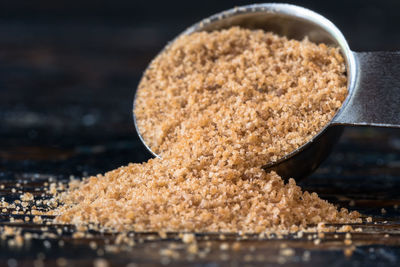Close-up of coconut palm sugar with measuring spoon on table
