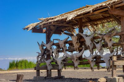 Traditional windmill on field against clear blue sky