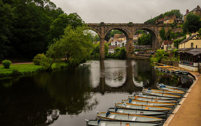 Arch bridge over river against sky