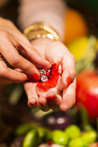 Close-up of woman holding red rose