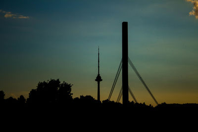 Silhouette of communications tower at dusk