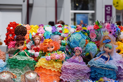 Close-up of colorful dolls for sale