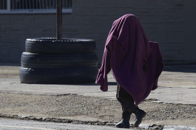 Rear view of woman walking on street