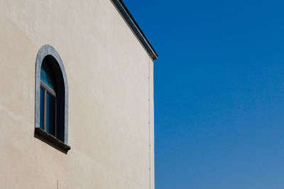 Low angle view of building against blue sky
