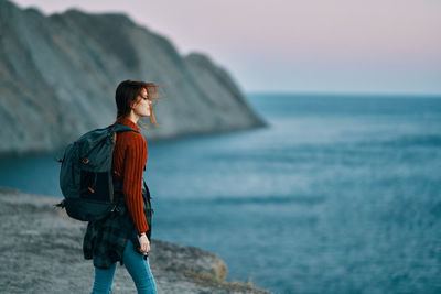 Man looking at sea against sky