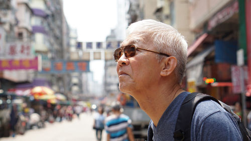 Portrait of man looking at city street