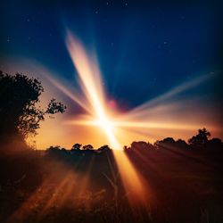 Scenic view of silhouette field against sky during sunset