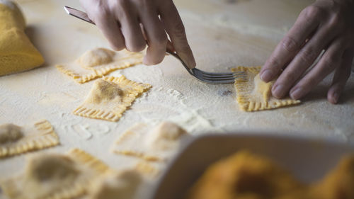 Cropped image of woman preparing food on table