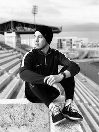 Man sitting on concrete wall