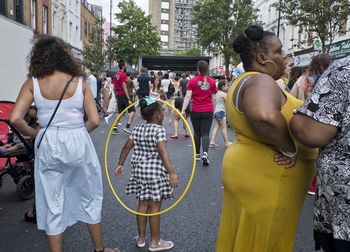 Rear view of people standing on street