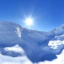 Scenic view of snow covered mountains against sky