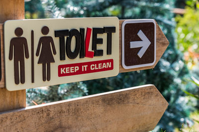 Close-up of road sign against trees