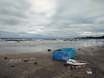 Garbage on beach against sky