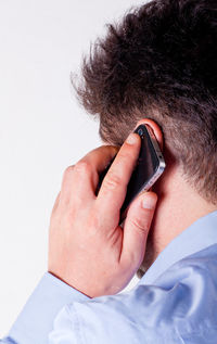 Low section of woman using mobile phone on bed