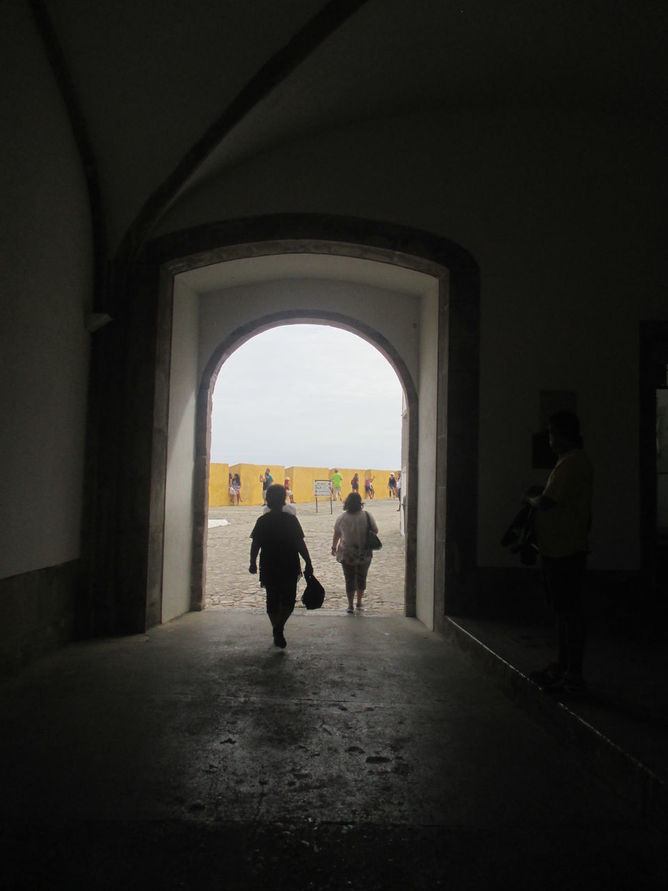 REAR VIEW OF SILHOUETTE MAN WALKING IN CORRIDOR