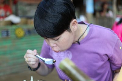 Close-up of woman eating food outdoors