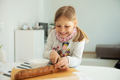 Portrait of happy girl with ice cream on table