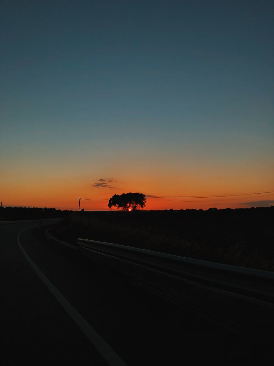 ROAD AGAINST SKY DURING SUNSET