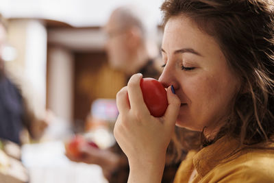 Side view of young woman using mobile phone