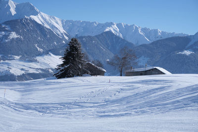 Scenic view of snow covered mountains against sky