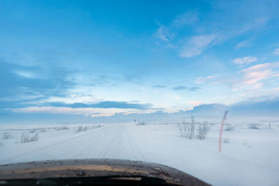 Snow covered road against sky