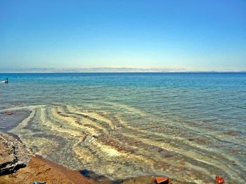 Scenic view of sea against clear blue sky