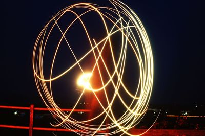 Light trails against clear sky at night