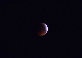 Low angle view of moon against sky at night