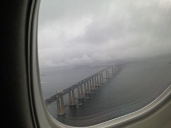 Cropped image of train against cloudy sky