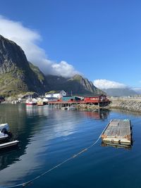 Scenic view of harbor and sea against blue sky