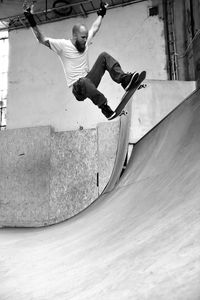 Low angle view of young man skating at skateboard park